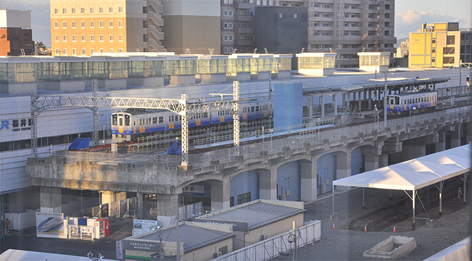 新幹線の高架を走る私鉄電車